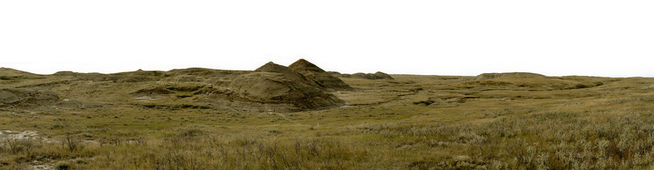 Panorama of pyramid shaped hills and green prairie grass with a transparent sky