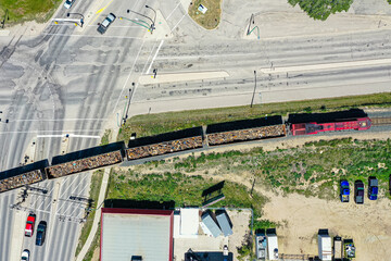 Train is traveling down a track next to a road