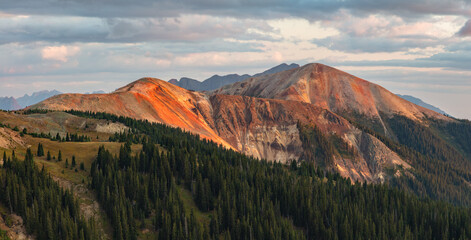 North Anvil (12,300') and Anvil Mountains (12,531') orange and red hues glowing at sunset.  Located...