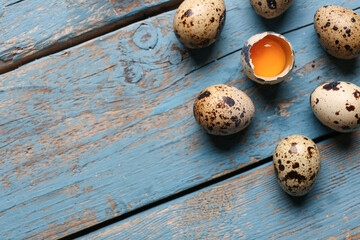 Fresh quail eggs on blue wooden background