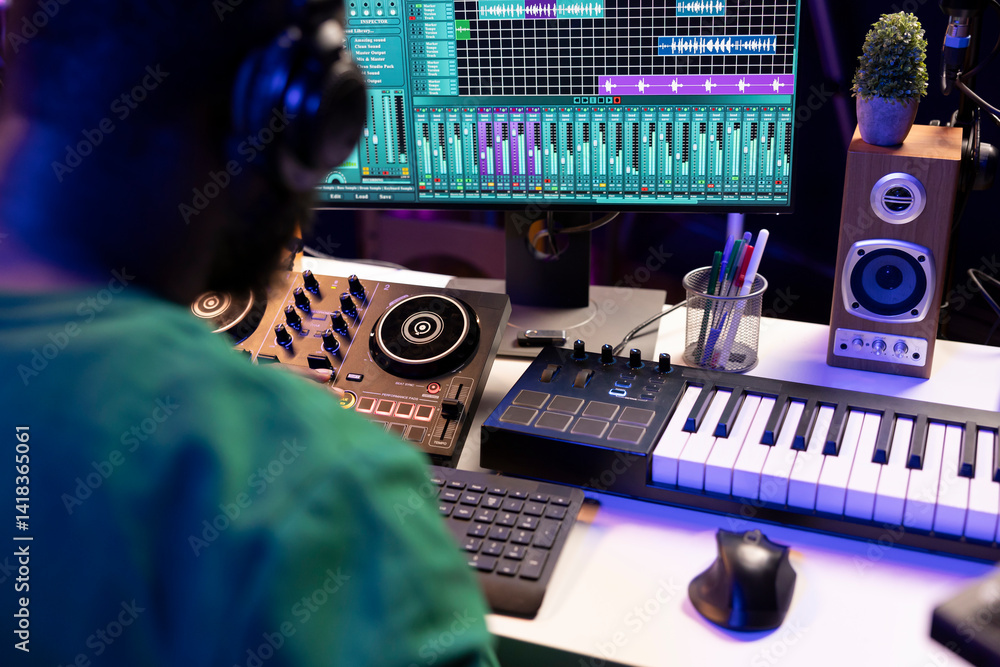 Poster Sound engineer mixing and mastering new music on console and daw software in home studio, twisting pre amp knobs. Talented composer producing songs for the industry. Close up.