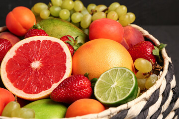 Bowl with different fresh fruits, closeup