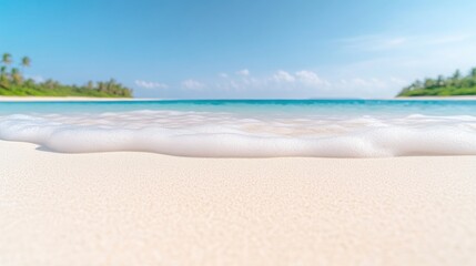 Fototapeta premium Gentle waves washing onto pristine white sandy beach, clear turquoise water and lush green palm trees in the distance, and serene tropical paradise.