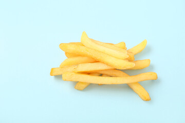 Tasty french fries on blue background
