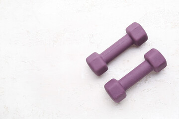 Purple dumbbells on white background