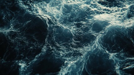 A close-up shot of a choppy, dark blue ocean surface with strong waves.