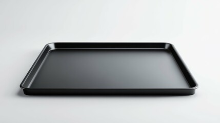 Minimalist image of an empty, black baking sheet on a clean white surface. 