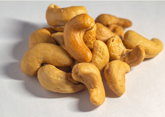 Cashew nuts. Handful of roasted cashew nuts on a white background.