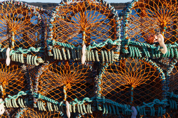 Stacks of crab traps on harbour in Scotland on a cold winters morning. 