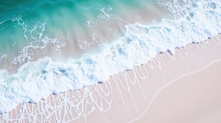 Aerial view of serene turquoise ocean waves on sandy beach.
