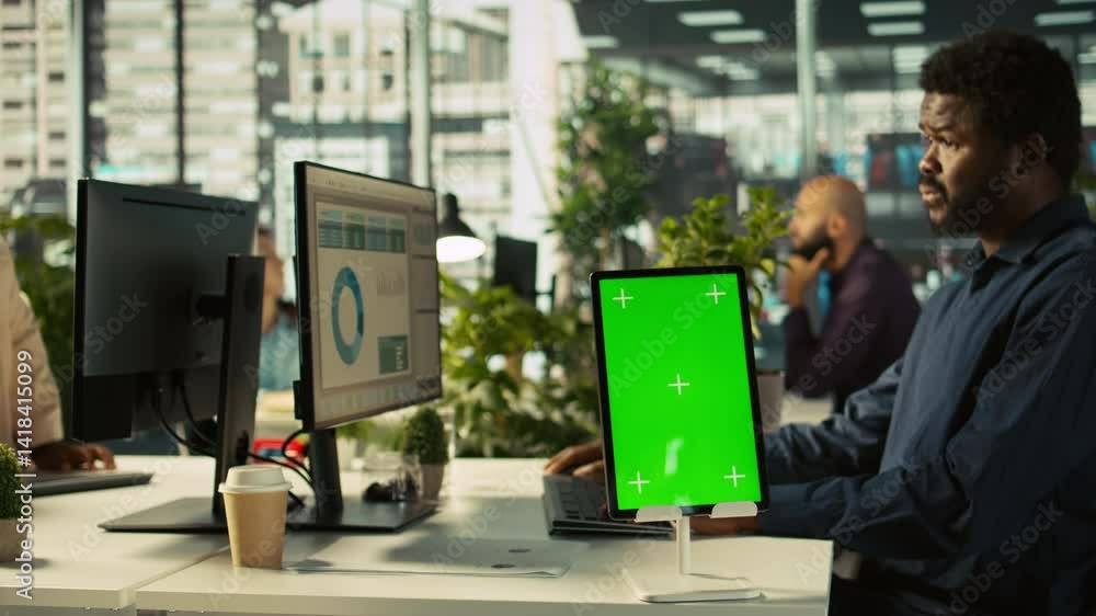 Poster close up of green screen tablet in front of employee checking progress done on project. chroma key d