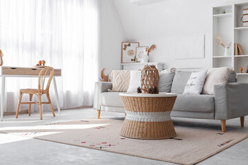 Interior of stylish living room with cozy sofa, shelving unit and coffee table
