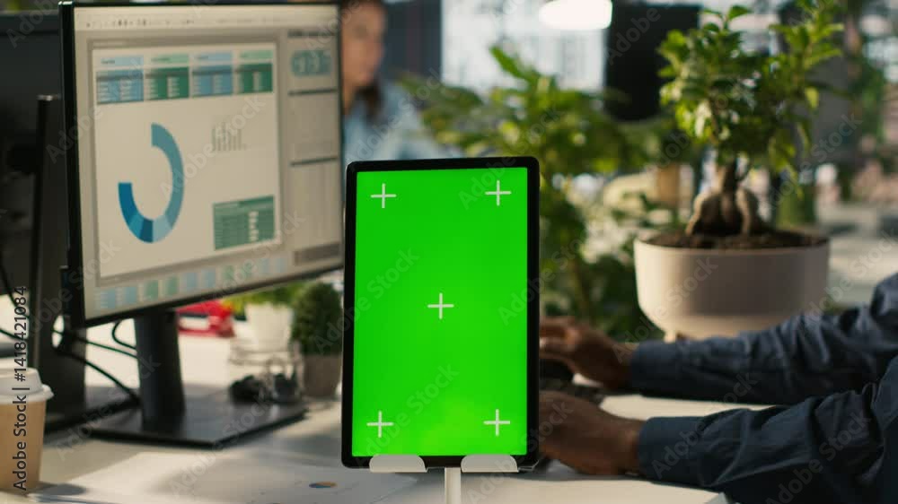Poster close up of green screen tablet in front of employee checking progress done on project. chroma key d