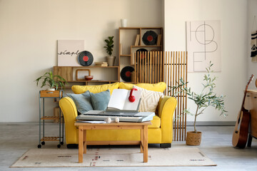 Interior of living room with sofa, synthesizer and vinyl disks