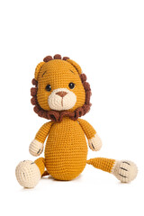 Cute knitted toy lion on white background