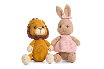 Cute knitted toys on white background