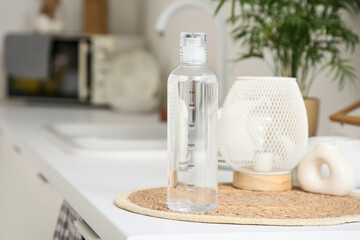 Bottle of water with time stamps on table in kitchen, closeup