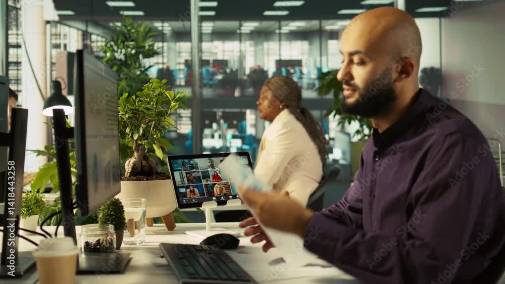 Poster worker in office talking with colleagues during internet videocall. employee at work discussing with
