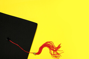 Mortar board on yellow background