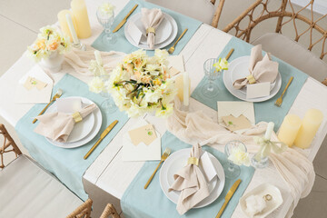 Table setting with beautiful narcissus flowers in room, top view