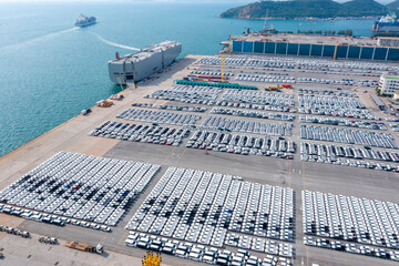 Aerial view of the huge ro-ro ship loading new cars. Automotive container carriers oversea...