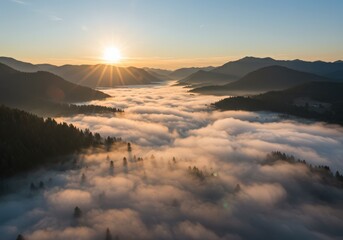 Stunning aerial view of mountains and a misty valley during a gorgeous sunrise.