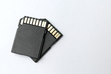 Two SD memory cards on white background, top view. Space for text