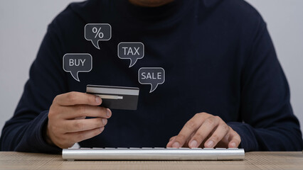 A close-up of a person holding a credit card while shopping online, demonstrating modern finance and e-commerce trends with digital payment options.