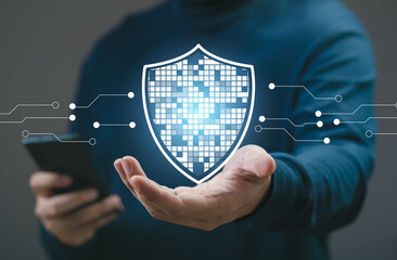 A person holds a smartphone with a digital security shield graphic overlay, symbolizing data...