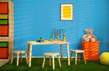 Cozy playroom with toys and furniture. Stylish children's room interior