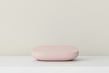 A light-pink, oval-shaped object sits on a white surface