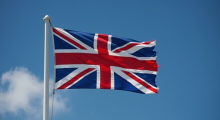 A Torn British Flag Waves Proudly Against a Vivid Blue Sky