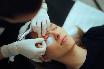 Beautician Prepares Eyelashes for the Lamination Procedure at the Salon. Woman goes to a beauty...