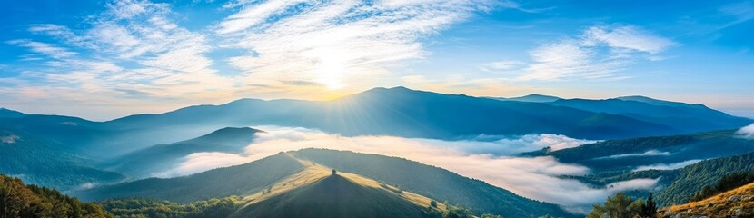 Panoramic view of Carpathian Mountains with foggy valley and sunlight on mountain peak under vibrant blue sky with clouds, wide high-resolution morning landscape background