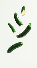 Fresh Green Zucchini Vegetables Floating in Air with White Background
