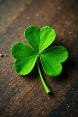 Naklejka premium Vibrant green four-leaf clover on wooden table, table, earthy