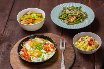 Jewish food tzimmes, chelnt, shakshuka for the holiday next to a fork