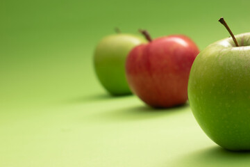 Green and red apples on colorful backgrounds – healthy eating and fruit concept