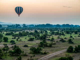 Hot Air Balloon Drifting Over a Green African Landscape at Dawn. Maasai Mara, Kenia, Africa.