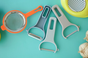 Kitchen tools and fresh ingredients on a turquoise surface