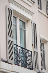 Elegant window with decorative metal balcony in urban setting