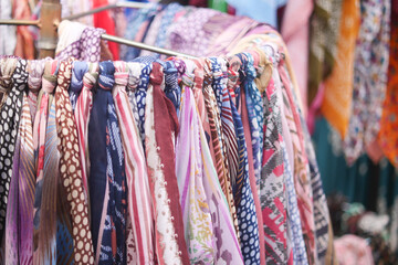 Variety of colorful scarves displayed in a market setting