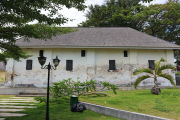 An old warehouse building with an ancient architectural style. Suitable for use as a background for ancient or horror themes  © Hary TS