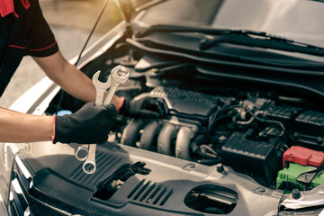 Technician auto mechanic holding wrench for fix service repairing change spare part engine problem...