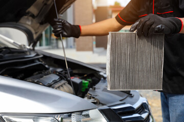 Technician auto mechanic holding car air conditioner filter for check and clean dirty or fix repair...