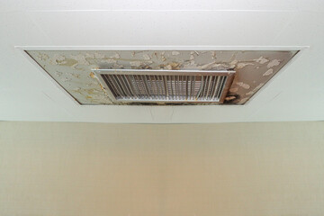 Water drop leak on air conditioner grille is ceiling stain and cracked and mold.