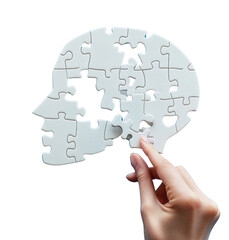 A person is holding a puzzle piece of a white head