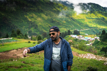 A mature Indian man enjoying his vacation in mountains in Himachal pradesh, india