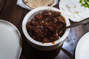 Close-up of spicy Indian-style Chicken Chilly served in a ceramic bowl — a popular Indo-Chinese dish made with crispy fried chicken, onions, and tangy sauces.