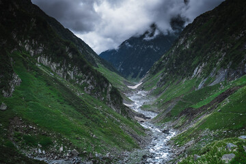 Beautiful landscape shot of a gorgeous Thamsar pass Himalayan mountain valley with dense forests...